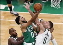  ?? MICHAEL DWYER - STAFF, AP ?? Boston Celtics’ Jayson Tatum (0) shoots over Milwaukee Bucks’ Brook Lopez (11) during the first half of an NBA basketball game Wednesday, Dec. 23, 2020, in Boston.