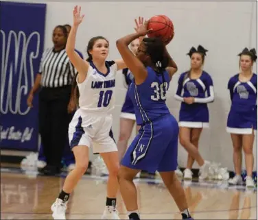  ?? Terrance Armstard/News-Times ?? PC pressure: Parkers Chapel's Kamryn Cross (10) plays defense against Nevada's Camyia Cody in the Lady Trojans' home opener this season. Girls basketball has tipped off in full force for Union County schools.