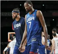  ?? ERIC GAY — THE ASSOCIATED PRESS ?? United States’ Javale Mcgee, left, a Flint native, and Kevin Durant walk off the court after their loss to France Sunday.
