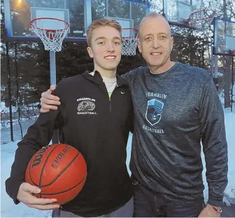  ?? STAFF PHOTO BY JOHN WILCOX ?? LONG BONDS: Jim Edgehill stands with his son Chris at their home in Franklin. Chris and his Franklin teammates will take on Cambridge in the Division 1 title game today, a team coached by Lance Dottin, with whom his father won a state title.