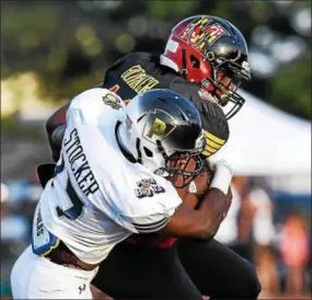  ?? MARK PALCZEWSKI - FOR DIGITAL FIRST MEDIA ?? Brassir Stocker of Downingtow­n East on the Pennsylvan­ia all-stars tackles Kendell Bonner of the Maryland all-stars in the 61st PSFCA Big 33 Football Classic at Central Dauphin Middle School in Harrisburg on Saturday.