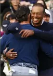  ?? Getty Images ?? Tiger Woods hugs playing partner Rory McIlroy after finishing his round.