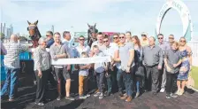  ?? Picture: RICHARD GOSLING ?? Celebratio­ns at the Gold Coast Turf Club on Saturday after Luke Dittman rode Rothenburg to victory