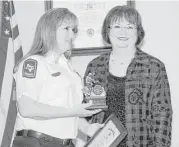  ?? George Wong / For the Chronicle ?? Katy Fire Department Battalion Chief Dana Massey, left, received the first Chief Gary Tilton Firefighte­r of the Year Award from JoAnn Tilton.