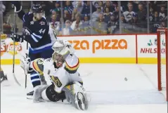  ?? CP PHOTO JOHN WOODS ?? Las Vegas Golden Knights goalie Maxime Lagace and Winnipeg Jets’ Josh Morrissey look on as the Jets’ shot from the point goes off the crossbar during second period in Winnipeg on Friday.