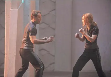 ??  ?? ABOVE: Brie Larson shows Jude Law some of her fighting skills. “I never had to throw a punch before this (film),” she says. “That has felt really good.” RIGHT: What fun is working out if you can't share your gym videos with a friend? Larson sent co-star Samuel L. Jackson clips of herself lifting crazy weights while training for “Captain Marvel.”
