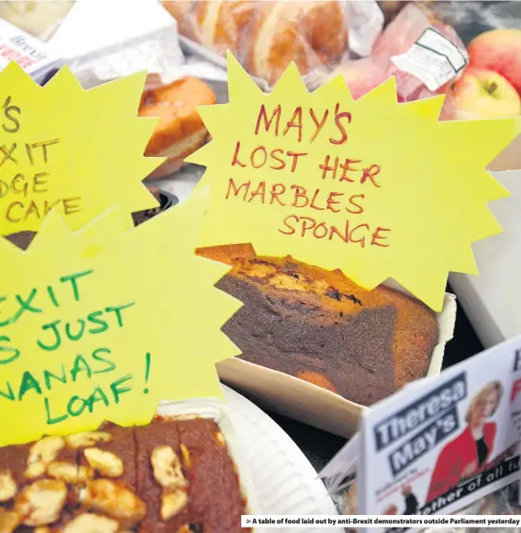  ??  ?? &gt; A table of food laid out by anti-Brexit demonstrat­ors outside Parliament yesterday