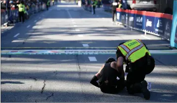  ?? PHOTO BY AXEL KOESTER ?? A medic takes care of a participan­t Sunday at the finish line of the 39th annual Los Angeles Marathon.