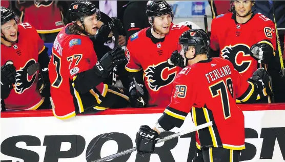  ?? AL CHAREST ?? Calgary Flames Micheal Ferland celebrates with teammates after scoring against the Washington Capitals at the Scotiabank Saddledome on Sunday.