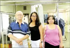  ?? Lynn Atkins/The Weekly Vista ?? Wayne Phillips poses with two of his employees, Maria Gallardo and Cindy Lopez, after his business, Village Dry Cleaners, announced it was shutting its doors.