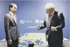  ?? ?? Boris Johnson greets Indonesian president Joko Widodo