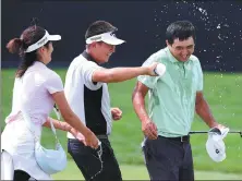  ?? GETTY IMAGES ?? Carl Yuan Yechun and Cathy Yuan douse Marty Dou Zecheng with water after Dou finishes the final round of The Ascendant at TPC Colorado on July 3, 2022 in Berthoud, Colorado. Dou won the tournament with a score of 17 under par.