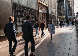  ?? Spencer Platt/Getty Images/TNS ?? People walk earlier this year along 5th Avenue in Manhattan, one of the nation’s premier shopping streets. U.S. retail sales continue to exceed forecasts, showing the strength of consumer demand.