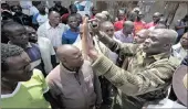  ?? PICTURE: AP ?? A police officer tries to calm the crowd in Kibera slum in Nairobi, Kenya, yesterday. Opposition parties said plans to continue with voting risked provoking violence.