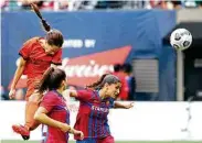  ?? Abbie Parr / Getty Images ?? Dash forward Shea Groom, left, gave her team a lead over Barcelona with her second-half goal.