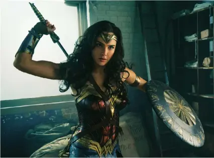  ??  ?? Below Gadot armed with tiara and shield in the title role of the new Wonder Woman movie