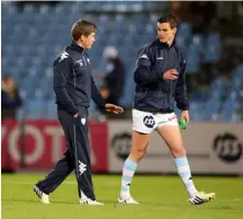  ??  ?? ABOVE: O’Gara, left, advises his former rival, Johnny Sexton, before a Racing 92 game
OPPOSITE PAGE
(FAR LEFT): Ireland’s ROG and BOD congratula­te Shane Horgan after scoring in Croke Park. OPPOSITE PAGE: The rugby star with his wife, Jessica