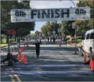  ??  ?? A child finishes the one-mile fun run during the Arsenal City Run on Sunday morning in Watervliet.