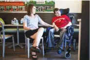 ?? MELISSA GOLDEN/THE NEW YORK TIMES ?? Kimberlee Harkins sits with her brother, Eric Harkins, at an ice cream parlor in Birmingham, Ala., last month. Eric has cerebral palsy and a developmen­tal disability and qualifies for 125 hours per week of help from a personal care assistant provided...