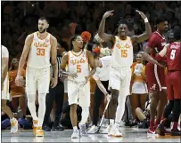  ?? WADE PAYNE — THE ASSOCIATED PRESS ?? Tennessee’s Jahmai Mashack, right, encourages fans as he leads Zakai Zeigler, center, and Uros Plavsic, left, on to the court on Wednesday in Knoxville, Tenn.