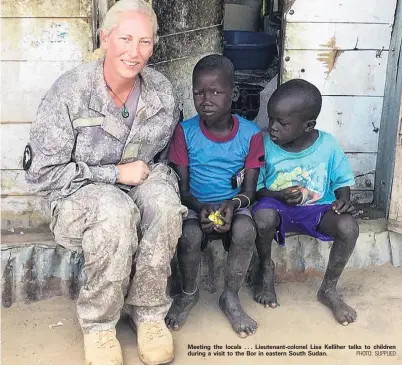  ?? PHOTO: SUPPLIED ?? Meeting the locals . . . Lieutenant­colonel Lisa Kelliher talks to children during a visit to the Bor in eastern South Sudan.