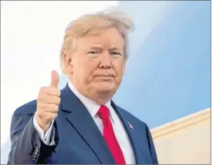  ?? AP PHOTO ?? President Donald Trump gives a thumbs up as he boards Air Force One at Andrews Air Force Base, Md., Nov. 3. Legal experts huddled together at a recent conference to ponder a question that could go from being a distant hypothetic­al to one that dominates...