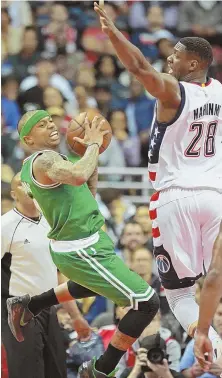  ?? STAFF PHOTO BY STUART CAHILL ?? ROAD TO NOWHERE: Isaiah Thomas looks to pass against the defense of the Wizards’ Ian Mahinmi during the Celtics’ 92-91 loss last night in Washington.