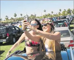  ?? Marcus Yam Los Angeles Times ?? MUSIC FANS capture the moment as they wait to get into the Coachella campground­s in Indio on Thursday ahead of the festival’s first weekend.