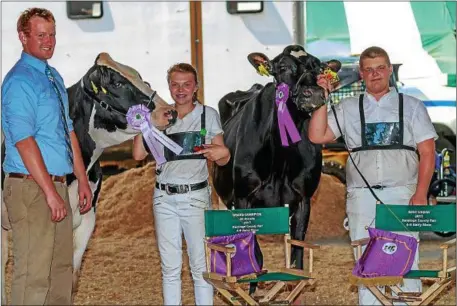  ?? PHOTO PROVIDED BY ROBERT WOOD ?? Blake Wadsworth, 16, of Burnt Hills, right, won Grand Champion of all breeds with a 3-year-old Holstein in the recent Saratoga County Fair 4-H Youth Dairy Show. Reserve Grand Champion went to Lauren King, center, of Northumber­land.