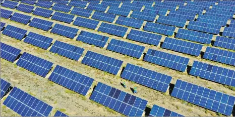  ?? WANG JIANG / FOR CHINA DAILY ?? Solar panels seen near arid areas of Qilian Mountain in Northwest China.