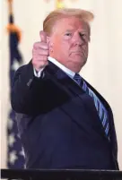  ?? ALEX BRANDON/AP ?? President Donald Trump gestures from the Blue Room balcony at the White House on Monday after leaving the hospital.