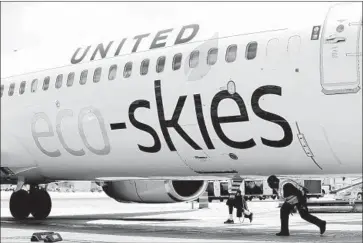  ?? Mario Tama Getty Images ?? A UNITED flight that used biofuel and carbon offsetting arrives at LAX on June 5, World Environmen­t Day.