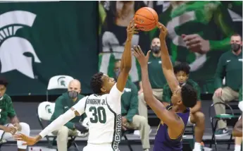  ?? GETTY IMAGES ?? Michigan State’s Marcus Bingham Jr. blocks a shot by Notre Dame’s Juwan Durham on Saturday.