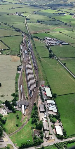  ??  ?? An aerial view looking south of just part of the vast rail facility at Long Marston, which is now managed by Porterbroo­k. The two-mile rail connection to Honeybourn­e disappears into the distance, leaving just a six-mile gap north to Stratford-upon-Avon, which begins by the buildings at the bottom of the photo. Porterbroo­k