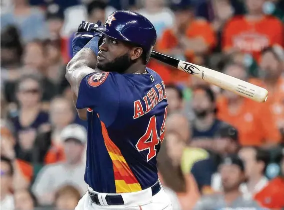  ?? Photos by Karen Warren / Staff photograph­er ?? Yordan Alvarez, who arrived in Houston with 23 homers to his credit at Round Rock, follows the flight of his first major league dinger in Sunday’s fourth inning.