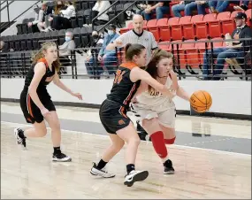  ?? TIMES photograph by Annette Beard ?? Senior Lady Blackhawk Hayley West works down court avoiding Lady Lion defenders Tuesday, Feb. 2.