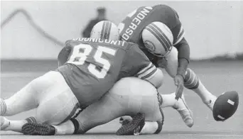  ?? Houston Chronicle file ?? Miami’s Nick Buoniconti and Dick Anderson force a fumble by Minnesota’s Doug Kingsriter at Rice Stadium. Houston had less than two years to get ready for the first Super Bowl played in Texas.