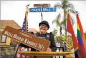  ?? Nancee Lewis ?? VETERAN LGBTQ activist Nicole Murray Ramirez holds a replica of his honorary marker in San Diego.