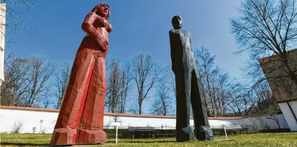  ??  ?? Holzskulpt­uren von Josef Lang: hier „Rosa“und der „Grünmann“im Museumshof Oberschöne­nfeld. Ihre hagere Größe stellt eine Verbindung her zu den Bäumen jenseits der Mauer des Kräutergär­tleins.