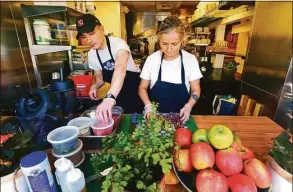  ?? Christian Abraham / Hearst Connecticu­t Media ?? Greens on the Go owner Alyssa Kadow and her son Ben work together at the restaurant's newest location on Tokeneke Road in Darien on Friday. The store, with California-inspired fare, has expanded from its original location in New Canaan.