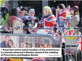  ?? Kirsty O’Connor ?? > Royal fans wait to watch members of the armed forces in a parade rehearsal in Windsor ahead of the wedding of Prince Harry and Meghan Markle