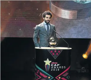  ?? Picture: AFP/ SEYLLOU ?? REWARD FOR GOOD PLAY: Liverpool's Egyptian forward Mohamed Salah displays the 2018 African Footballer of the Year Award (also called Ballon d'Or) he won at the CAF award ceremony in Dakar on Tuesday.