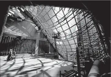  ??  ?? A WORKER frames steel for a skylight inside the Wilshire Grand Center’s atrium. Constructi­on is expected to be completed on March 8, 2017, the birthday of Yang Ho Cho, chairman of Hanjin Internatio­nal Corp.