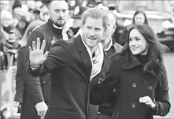  ??  ?? Prince Harry and his fiancee Markle greet wellwisher­s on a walkabout as they arrive for an engagement at Nottingham Contempora­ry in Nottingham, central England, on Friday. (Right) Harry and Meghan visit the Nottingham Academy school. (Below, left to...