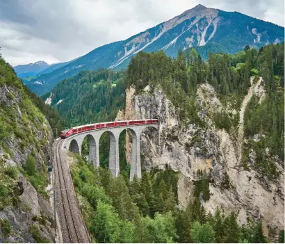  ?? ?? The Bernina Express travels along the Landwasser Viaduct.