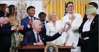  ?? (AP/Patrick Semansky) ?? President Joe Biden hands a pen he used to sign his executive order to activist Javier Gomez Wednesday at a White House event to celebrate Pride Month.