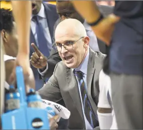  ?? Phelan M. Ebenhack / Associated Press ?? UConn coach Dan Hurley, center, talks to his players during a timeout.
