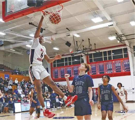  ?? ALLEN CUNNINGHAM/SUN-TIMES ?? West Aurora junior Terrence Smith throws down a dunk against Oswego East for two of his 22 points Tuesday night in Aurora.