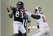  ?? MATT GENTRY/ASSOCIATED PRESS ?? The Hokies’ Tayvion Robinson, left, a Cox High alum, catches a touchdown pass in front of Malik Dunlap, right, Saturday night in Blacksburg.