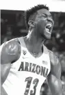  ?? Isaac Brekken/AP ?? ■ Arizona’s Deandre Ayton reacts after a dunk against Southern California during the second half of an NCAA basketball game for the Pac-12 men’s tournament championsh­ip on March 10 in Las Vegas. Ayton was a force in his lone college season and looks like the favorite to land with Phoenix as the No. 1 overall pick in Thursday’s NBA Draft.